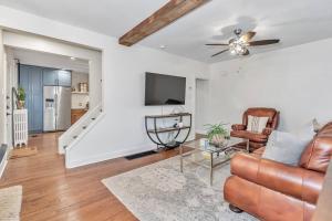 a living room with a couch and a tv at Underground Railroad 3 Bedroom Farmhouse in Kennett Square