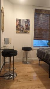 a room with two stools and a table and a window at CENTRAL PARK EAST and MUSEUMS in New York