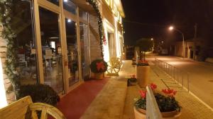 a building with flowers on a street at night at Simona Rooms in Portocannone +9 photos