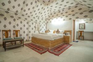 a bedroom with a large bed in a tent at Dynasty Desert Camp and Resort in Sām +24 photos