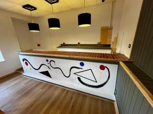 a counter with a painting on it in a room at The Orange Teddy Bear Hostal La Peña in Mieres