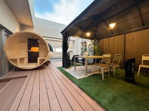 a patio with a table and chairs on a deck at HOTEL felice in Toyonaka