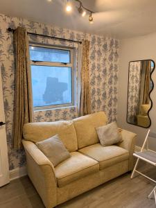 ein Wohnzimmer mit einem Sofa und einem Fenster in der Unterkunft Parnell Place Apartments in Dublin