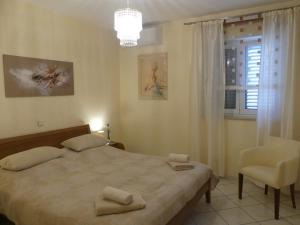 sypialnia z łóżkiem, krzesłem i oknem w obiekcie Villa Skoric w Orebiciu