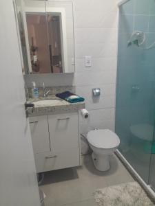 a bathroom with a toilet and a sink and a shower at Beira-mar in Santos +20 photos