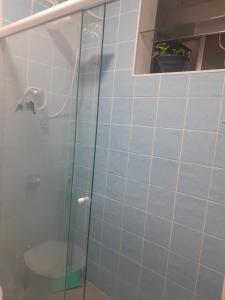 a bathroom with a glass shower with a toilet at Beira-mar in Santos +12 photos