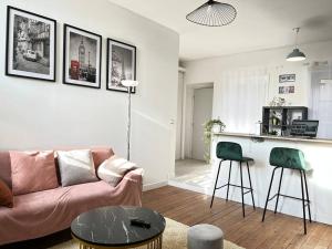 a living room with a couch and a table at Le petit Rochambeau in Vendôme