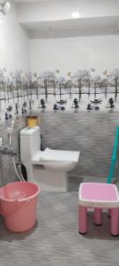 a bathroom with a toilet and a bath tub at P V J RESIDENCY Home Stay in Pithāpuram