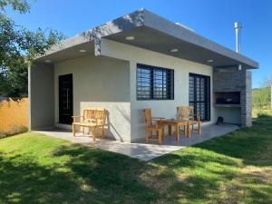 Casa pequeña con patio con mesa y sillas en Aires Casas de campo en Villa Santa Cruz del Lago