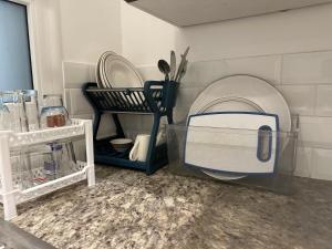 a kitchen with a dishwasher and plates and utensils at Hawana salalah luxury studio in Wādī Khasbar