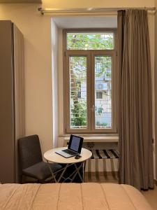 a bedroom with a laptop on a table next to a window at Wanda Bed&Breakfast in Naples