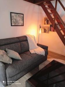 a living room with a couch and a table at Maisonnette in La Croix-en-Touraine