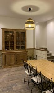 a dining room with a large wooden table and chairs at Gîte de la Forge, l'Atelier in Fléré-la-Rivière +25 photos