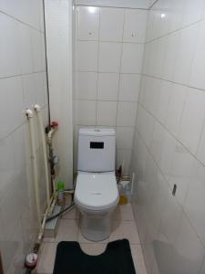 a small bathroom with a white toilet in a room at ЯРКАЯ ЗВЕЗДА НА КОСМОСЕ ! in Aktobe