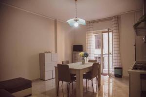 a kitchen and dining room with a table and chairs at Campania Apartment Vesuvio Comfort -150m dalla stazione - 5km da Pompei in Poggiomarino +20 photos