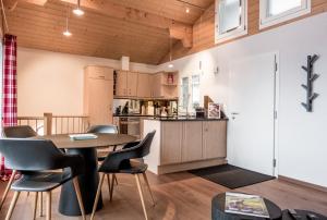 a kitchen and dining room with a table and chairs at Chalet Eiger View - GRIWA RENT in Grindelwald +11 photos