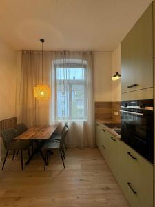 a kitchen with a table with chairs and a window at H-36 RESIDENCE - BRIGHT Collection in Koblenz