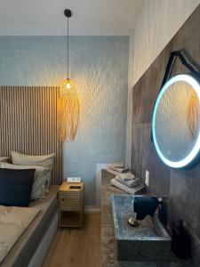 a bedroom with a mirror and a bed and a table at H-36 RESIDENCE - BRIGHT Collection in Koblenz +66 photos