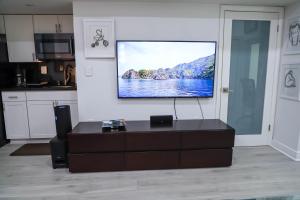 a living room with a flat screen tv on a wall at VILLA GUILLA in Miami
