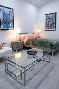 a living room with a bed and a glass table at VILLA GUILLA in Miami