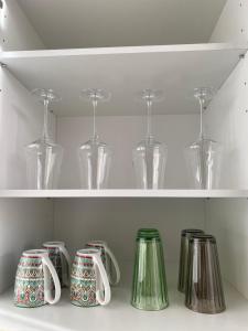 a row of cups and glasses on a shelf at H-36 RESIDENCE - BRIGHT Collection in Koblenz