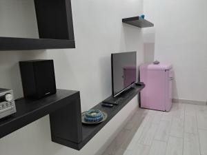 a kitchen with a pink refrigerator in a room at Dimora Nonna Rosa in Aversa