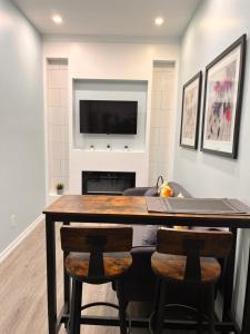 a living room with a table and a television at Private Apartment/Suite in Whitby