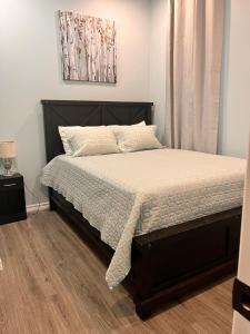 a bedroom with a bed with a wooden floor at Private Apartment/Suite in Whitby