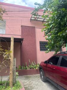 a red car parked in front of a house at RESIDENCIAL SOPHIA in Eunápolis