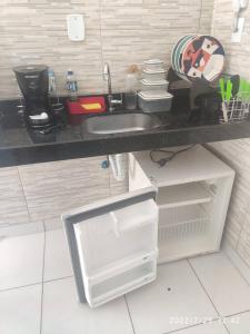 a small kitchen with a sink and a refrigerator at RESIDENCIAL SOPHIA in Eunápolis