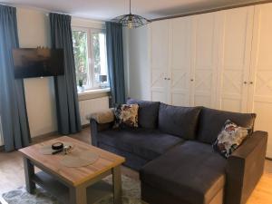 a living room with a couch and a table at Apartament Promyk in Świnoujście +13 photos
