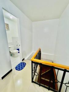a bathroom with a staircase and a toilet in a room at tranisient house @camella villa kanangga butuan city in Butuan