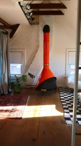 a living room with an orange object on the floor at Creative Private Attic 1br Suite in Honey Brook
