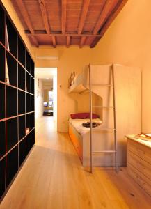 a room with a refrigerator and a bed in it at Eulalia's House in Modena