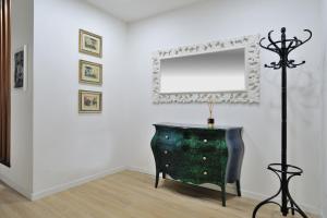 a room with a dresser and a mirror on a wall at Eulalia's House in Modena