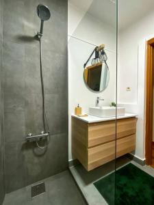 a bathroom with a shower and a sink and a mirror at Ocean View in Vila do Conde +20 photos