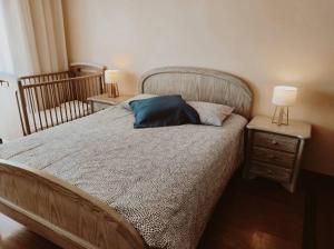 a bedroom with a bed with two night stands and two lamps at Ocean View in Vila do Conde