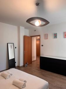 a bedroom with a bed and a large light fixture at Orea Spiti - Modern Oasis Near Milan in Assago