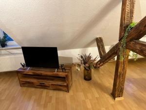 a living room with a flat screen tv on a table at Ferienwohnung Jule in Wernigerode