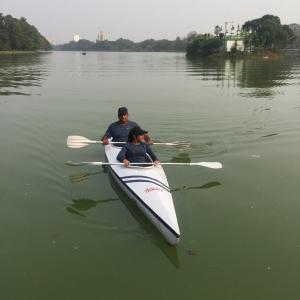 two people in a paddle boat on a lake at A Cosy (Greek Style) Den in Kolkata