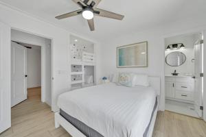a white bedroom with a bed and a ceiling fan at Laguna Point #6 Holiday Isle Free Activities in Destin