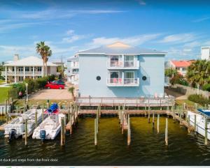 a house on a dock with boats in the water at Laguna Point #6 Holiday Isle Free Activities in Destin