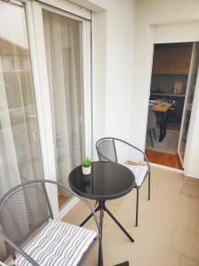 a black table and two chairs on a balcony at Riverside LUX Apartment in Pirot
