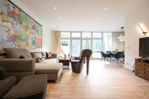 a living room with a couch and a table at Suite mit Moselblick in Traben-Trarbach