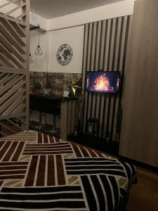 a bedroom with a bed and a tv on a wall at President Kop A4 in Kopaonik