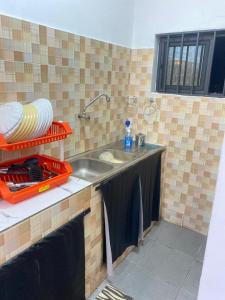 a kitchen with a sink and a counter top at Charly-chic@ in Cotonou