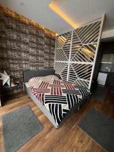 a bedroom with a bed in a room with rugs at President Kop A4 in Kopaonik
