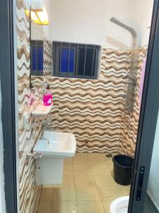a bathroom with a sink and a mirror at Charly-chic@ in Cotonou