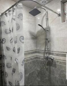 a shower with a shower curtain in a bathroom at SD House in Dilijan