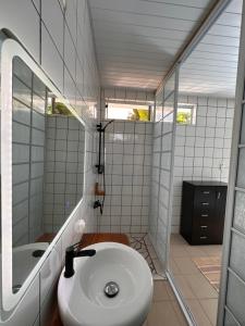 a bathroom with a toilet and a sink and a tub at Meri Lodge Huahine XXThe Bee HouseXX in Fare